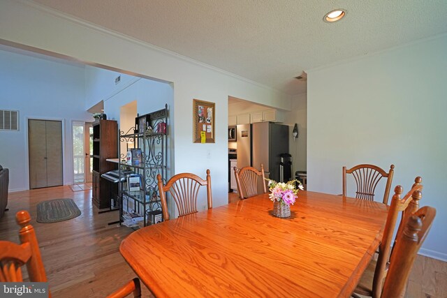 33955 Middleton Cir Unit 5, Lewes, DE 19958 - dining space featuring ornamental molding, wood finished floors, a textured ceiling, and recessed lighting