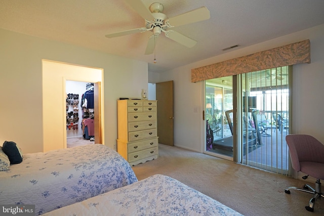 33955 Middleton Cir Unit 5, Lewes, DE 19958 - bedroom with light colored carpet, access to outside, a walk in closet, and a ceiling fan