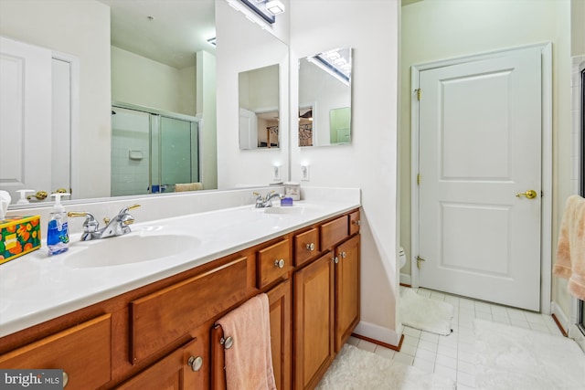 1507 Broadneck Pl Unit 403, Annapolis, MD 21409 - bathroom with a shower stall, double vanity, tile patterned flooring, toilet, and baseboards