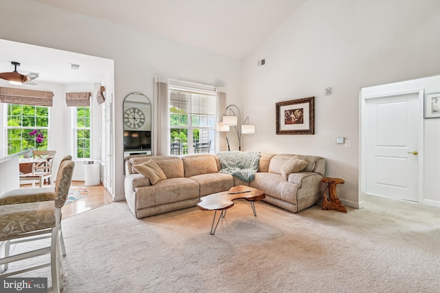 1507 Broadneck Pl Unit 403, Annapolis, MD 21409 - living room featuring healthy amount of natural light, high vaulted ceiling, light carpet, ceiling fan, and baseboards