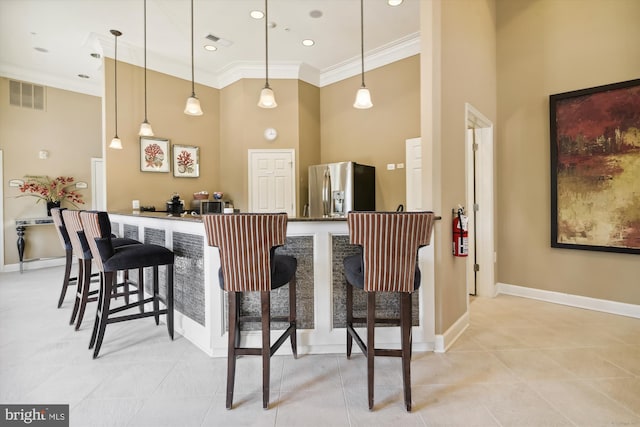 1507 Broadneck Pl Unit 403, Annapolis, MD 21409 - bar featuring stainless steel fridge, a towering ceiling, ornamental molding, light tile patterned floors, and baseboards