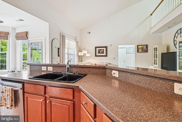 1507 Broadneck Pl Unit 403, Annapolis, MD 21409 - kitchen featuring open floor plan, stainless steel dishwasher, a sink, dark countertops, and brown cabinetry