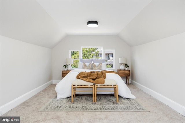 bedroom with baseboards, vaulted ceiling, and carpet
