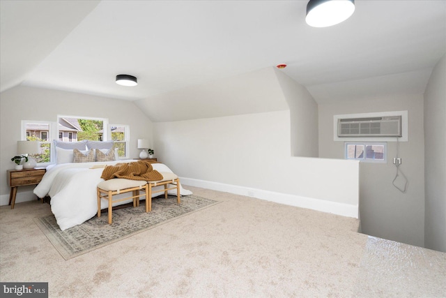 carpeted bedroom featuring baseboards, a wall mounted AC, and lofted ceiling