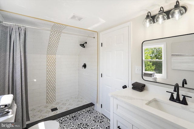 bathroom with vanity, a stall shower, tile patterned floors, and visible vents