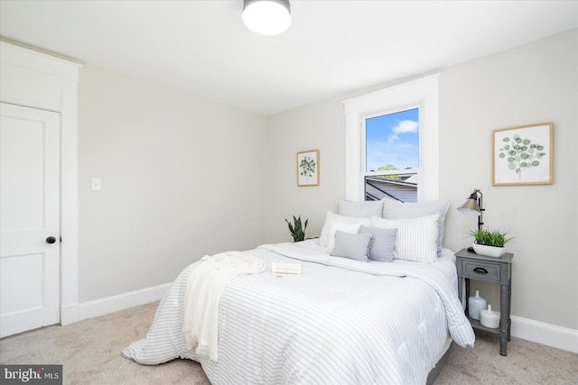 bedroom featuring baseboards and carpet flooring