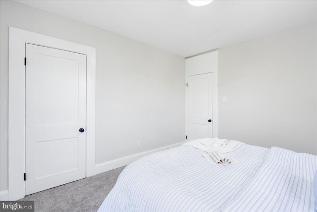 carpeted bedroom featuring baseboards