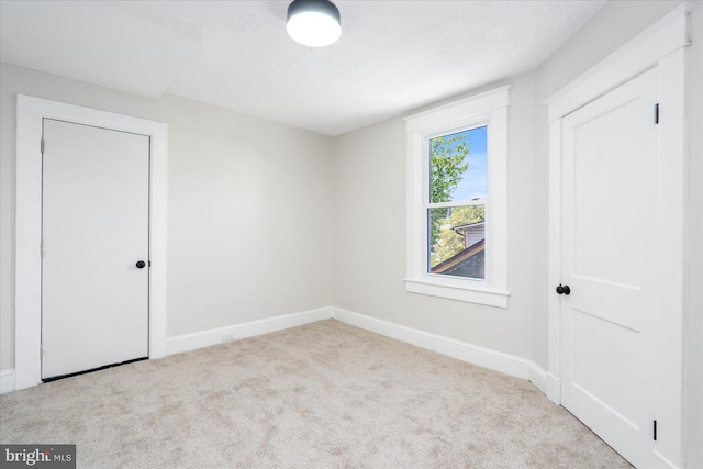carpeted spare room with baseboards