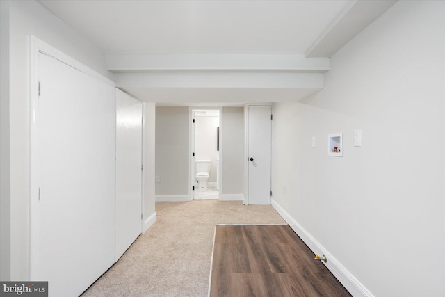 hallway with baseboards and carpet