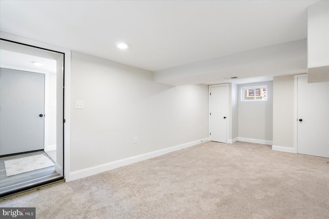 finished below grade area featuring recessed lighting, baseboards, light colored carpet, and visible vents