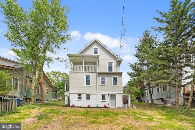 back of house with central AC unit and a balcony