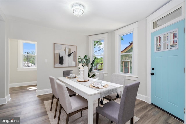 dining room with baseboards and dark wood finished floors