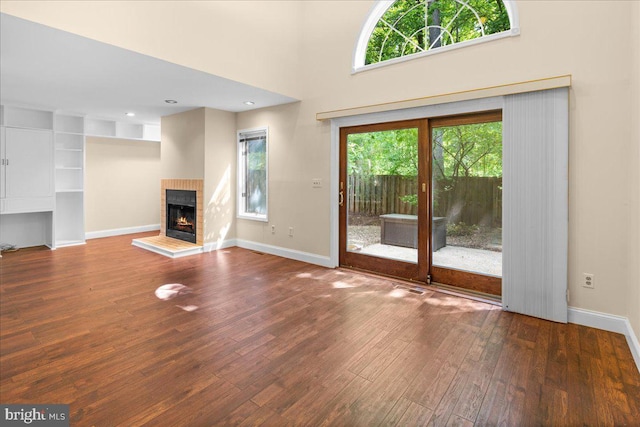 30 Morton Ct, Lawrence Township, NJ 08648 - unfurnished living room with hardwood / wood-style floors, baseboards, a fireplace, and a high ceiling