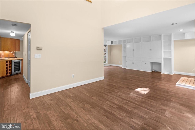 30 Morton Ct, Lawrence Township, NJ 08648 - unfurnished living room featuring wine cooler, wood finished floors, baseboards, and built in shelves