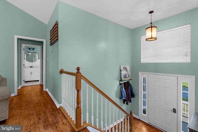 11312 Rawhide Rd, Lusby, MD 20657 - entryway featuring baseboards, wood finished floors, and high vaulted ceiling