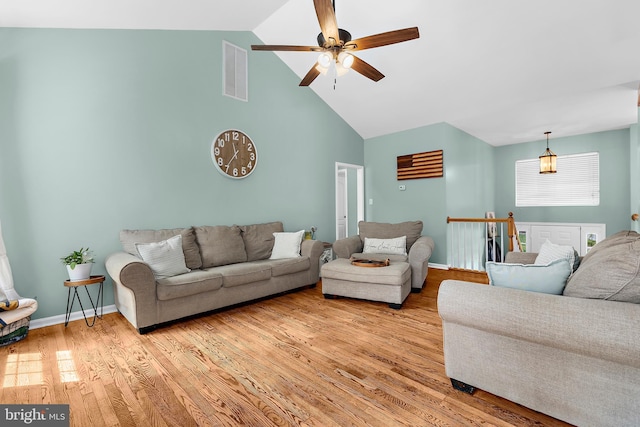 11312 Rawhide Rd, Lusby, MD 20657 - living room with visible vents, light wood-style floors, baseboards, ceiling fan, and high vaulted ceiling