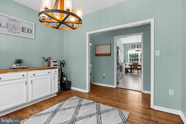 11312 Rawhide Rd, Lusby, MD 20657 - dining space with baseboards, wood finished floors, and a chandelier
