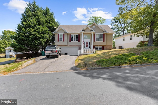 11312 Rawhide Rd, Lusby, MD 20657 - raised ranch with an attached garage and aphalt driveway