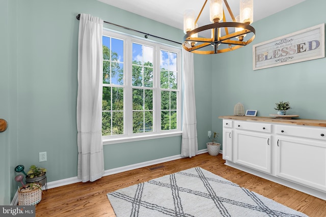 11312 Rawhide Rd, Lusby, MD 20657 - interior space featuring an inviting chandelier, plenty of natural light, light wood-style floors, and visible vents