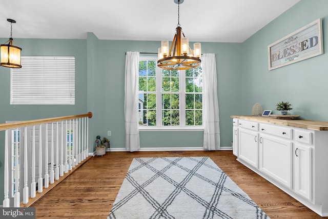11312 Rawhide Rd, Lusby, MD 20657 - entryway featuring an inviting chandelier, baseboards, and wood finished floors
