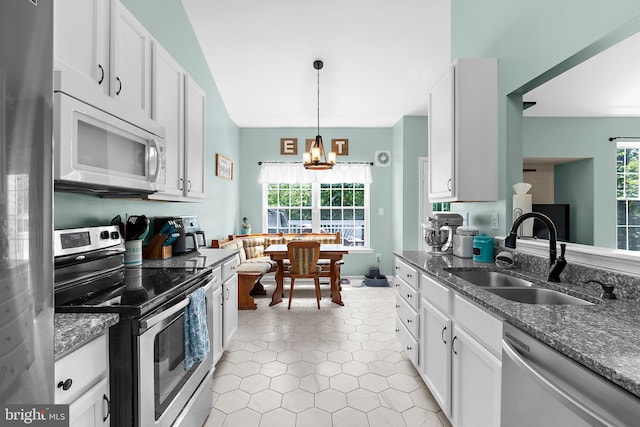 11312 Rawhide Rd, Lusby, MD 20657 - kitchen with a sink, appliances with stainless steel finishes, white cabinets, and dark stone countertops