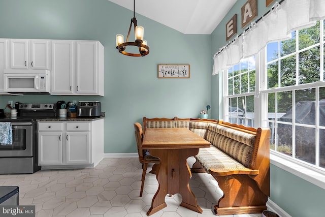 11312 Rawhide Rd, Lusby, MD 20657 - dining room featuring light tile patterned floors, baseboards, breakfast area, lofted ceiling, and an inviting chandelier