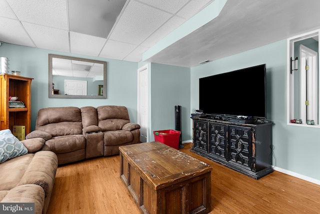 11312 Rawhide Rd, Lusby, MD 20657 - living area featuring baseboards, a drop ceiling, and wood finished floors