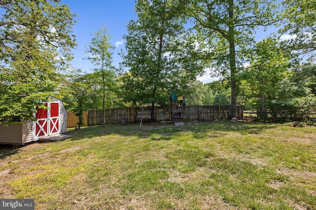 11312 Rawhide Rd, Lusby, MD 20657 - view of yard featuring an outdoor structure, a fenced backyard, and a shed