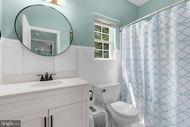 11312 Rawhide Rd, Lusby, MD 20657 - full bathroom with vanity, a shower with shower curtain, a wainscoted wall, and toilet