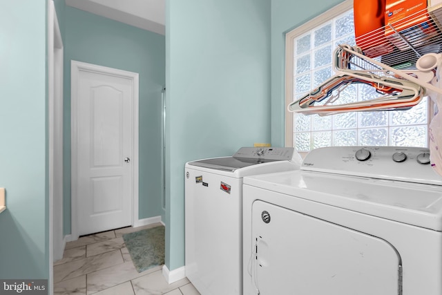 11312 Rawhide Rd, Lusby, MD 20657 - washroom featuring a healthy amount of sunlight, baseboards, independent washer and dryer, and marble finish floor