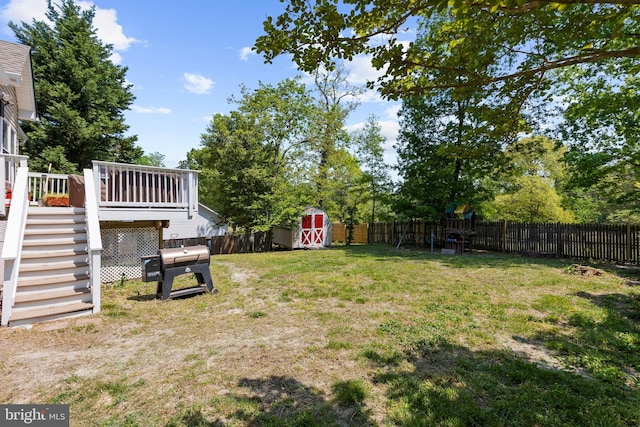 11312 Rawhide Rd, Lusby, MD 20657 - view of yard featuring a deck, a fenced backyard, a storage unit, an outbuilding, and stairway