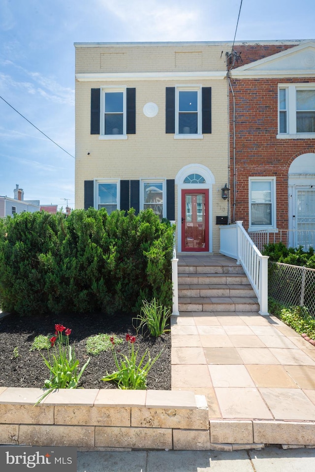 townhome / multi-family property with brick siding