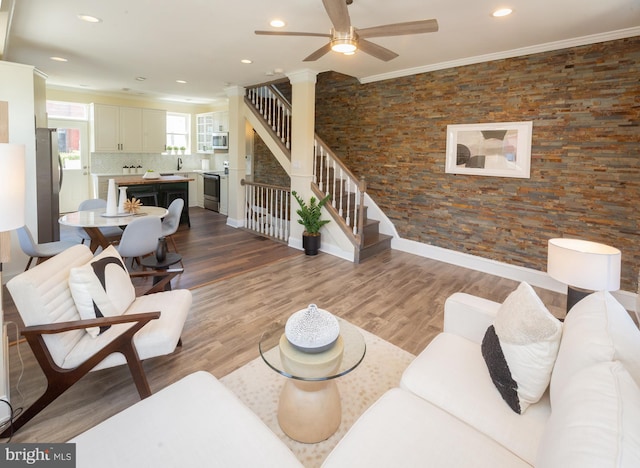 living room with stairs, recessed lighting, ceiling fan, and wood finished floors
