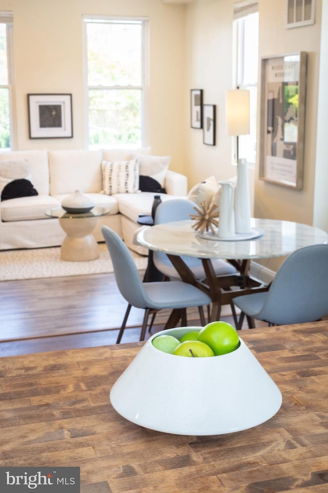 dining area featuring visible vents and wood finished floors