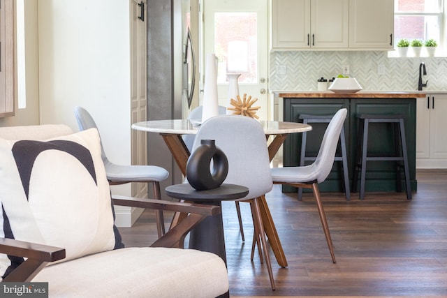 dining space with dark wood-type flooring