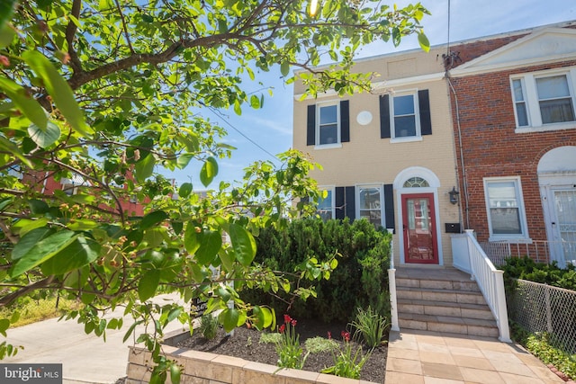 multi unit property featuring brick siding and fence