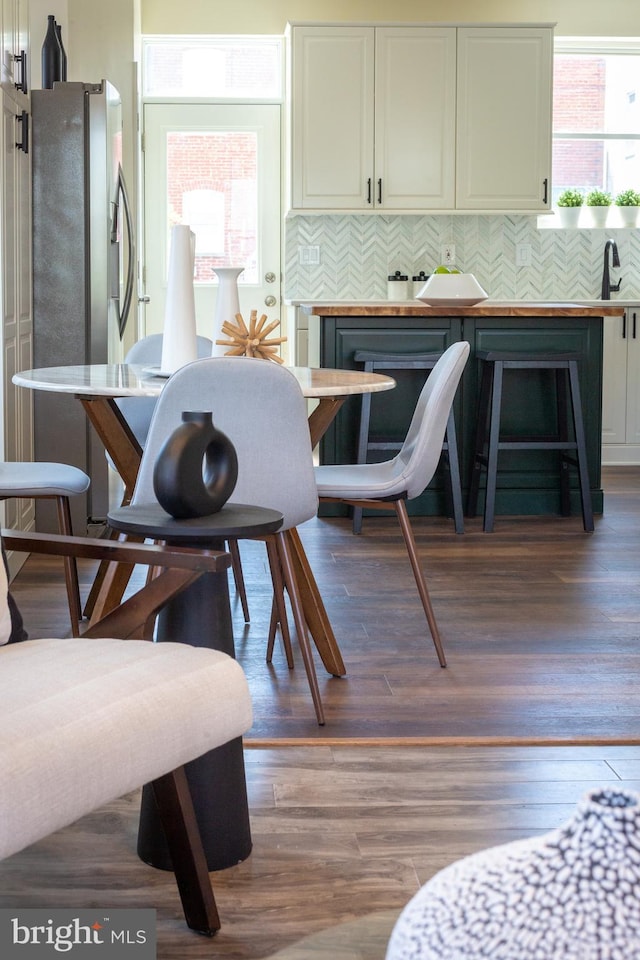 dining space with wood finished floors