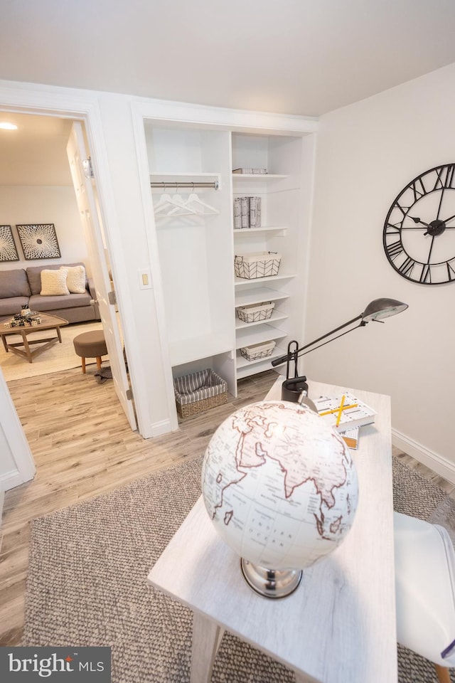 room details with baseboards and wood finished floors