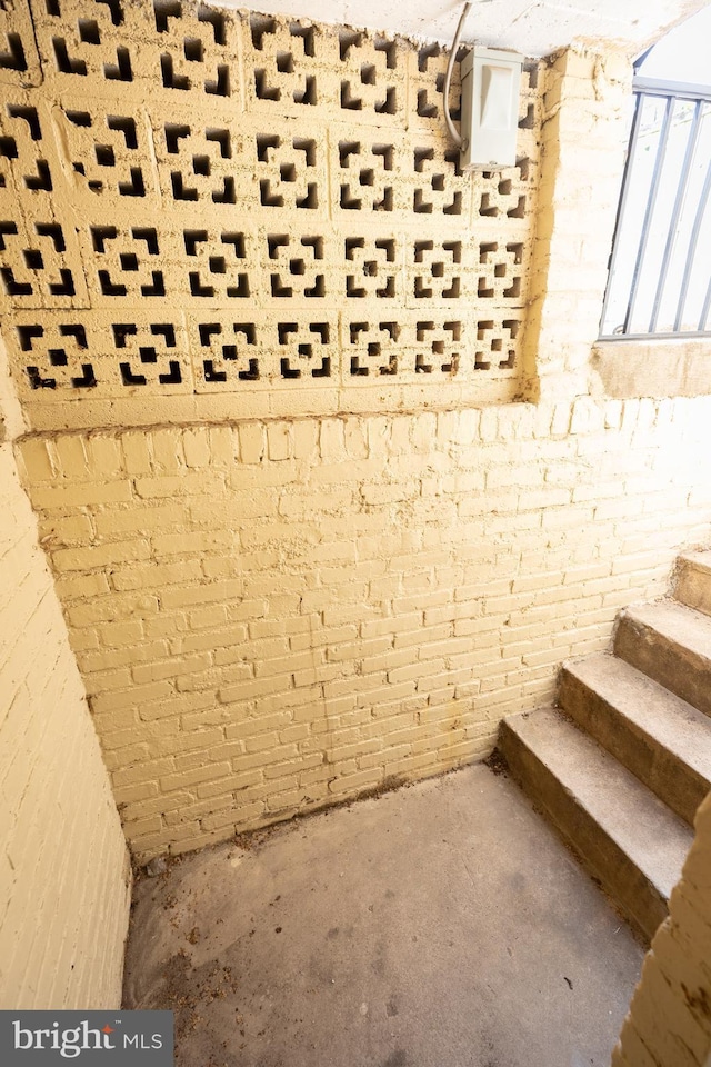 interior space with brick wall and stairway