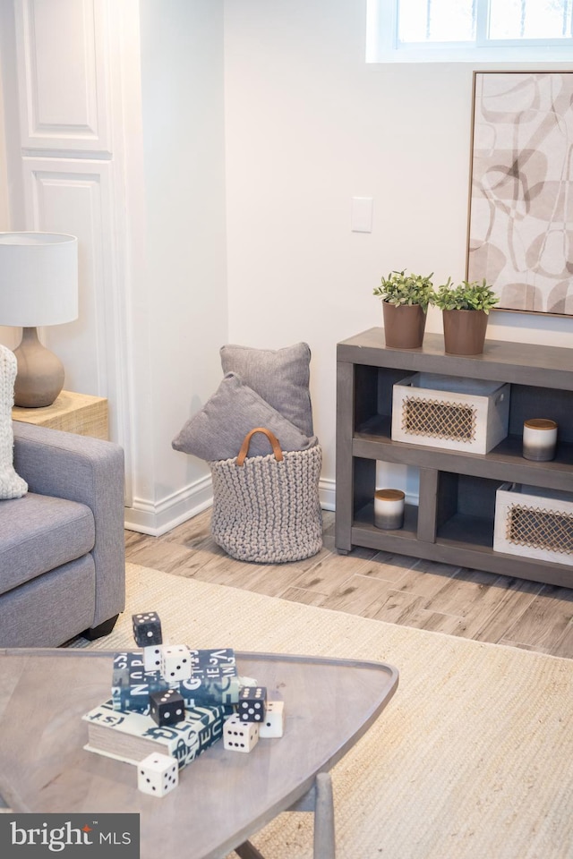 living room with baseboards and light wood-style flooring