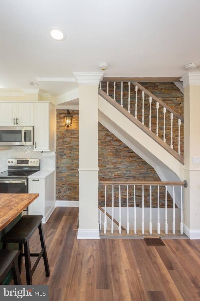 interior space with baseboards, dark wood finished floors, and stairs