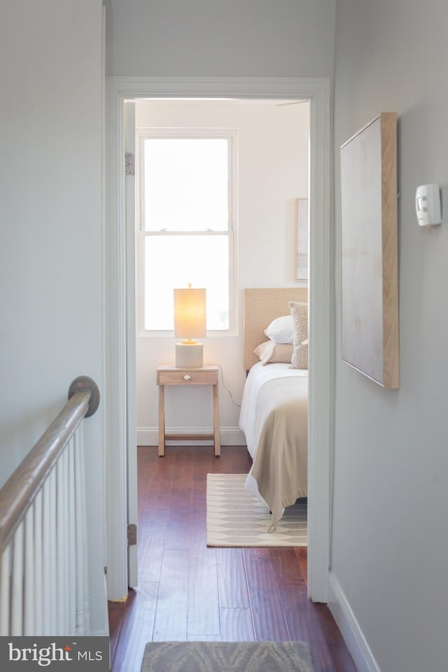 bedroom featuring baseboards and wood finished floors