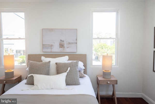 bedroom with baseboards and dark wood-style floors