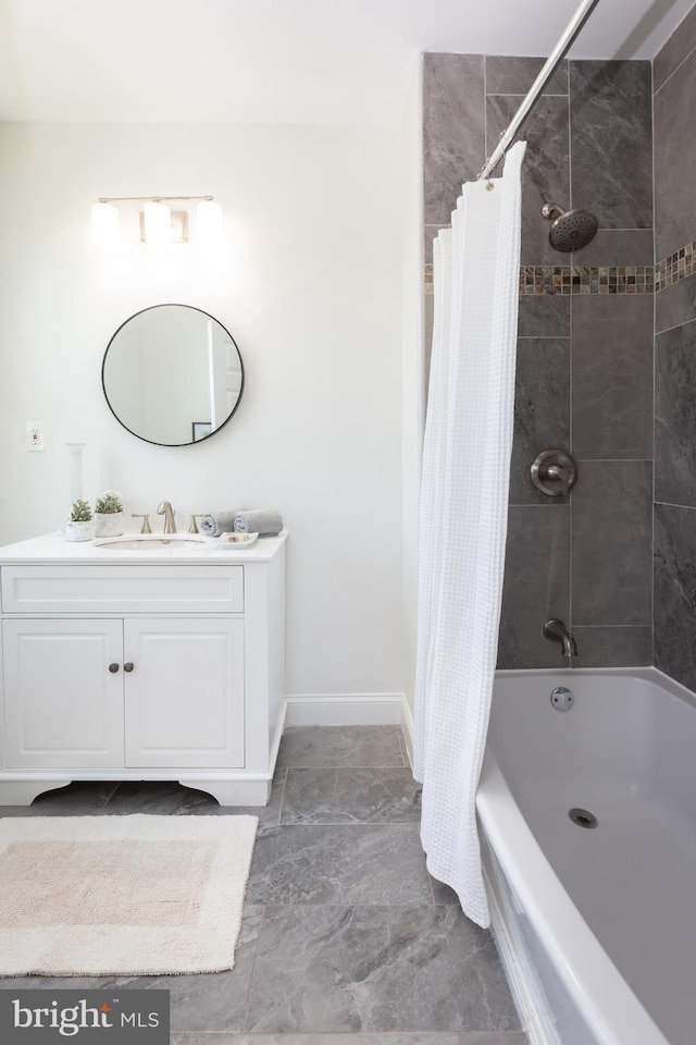 full bath featuring vanity, baseboards, and shower / tub combo with curtain