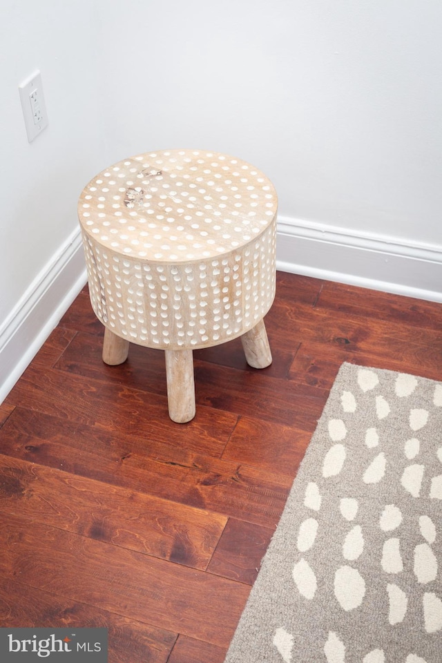 details featuring baseboards and wood finished floors