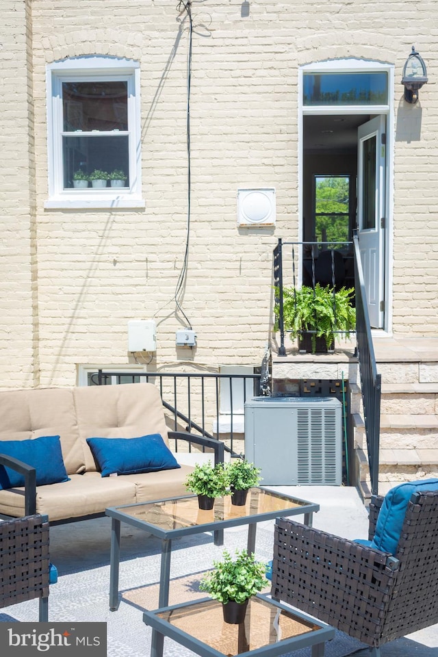 view of patio / terrace with an outdoor hangout area, central air condition unit, and a balcony