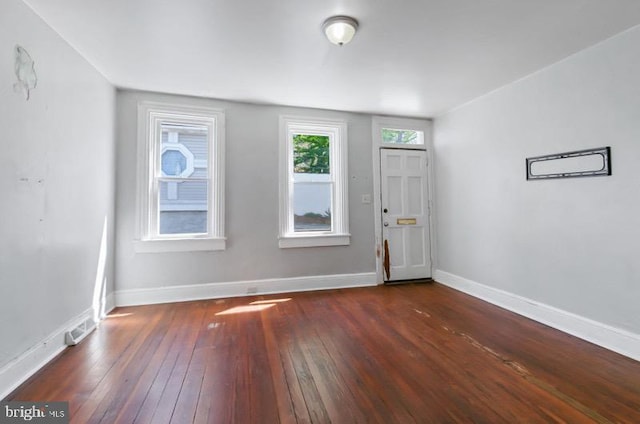 foyer entrance featuring dark wood-style flooring, baseboards, and visible vents