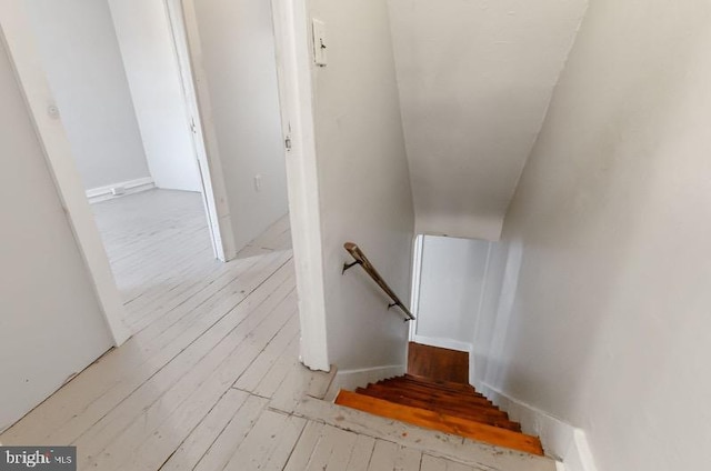 stairs featuring wood finished floors
