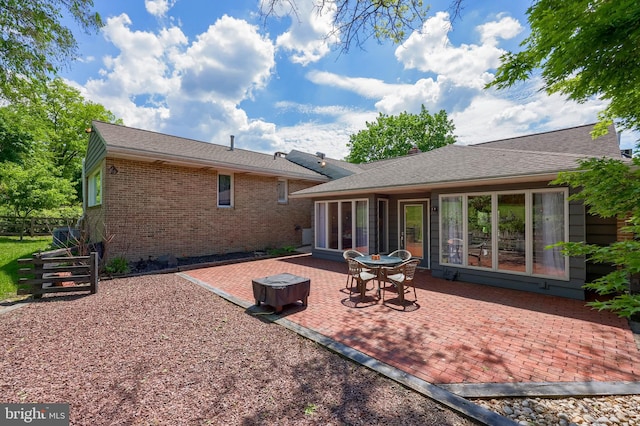 1515 Rockland St, Reading, PA 19604 - rear view of property featuring brick siding, a patio, and fence