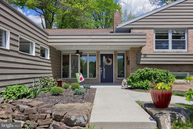 1515 Rockland St, Reading, PA 19604 - view of exterior entry featuring brick siding, a chimney, and a porch